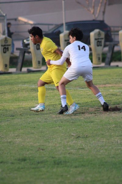 Senior Santiago Iniguez (white) defending against San Fernando (yellow)
